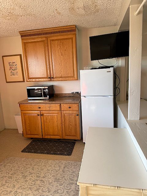 Kitchen work area. Bedroom to the right.