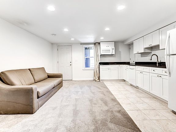 Living room and kitchen with front entrance