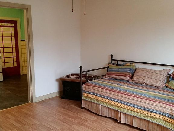 Living area looking into the kitchen. Ceiling fan.