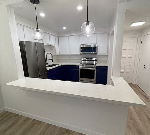 Large kitchen with large counter with overhang great for stools and eating