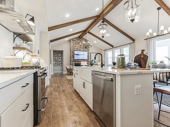 Kitchen with stained ceiling beams vaulted ceiling
