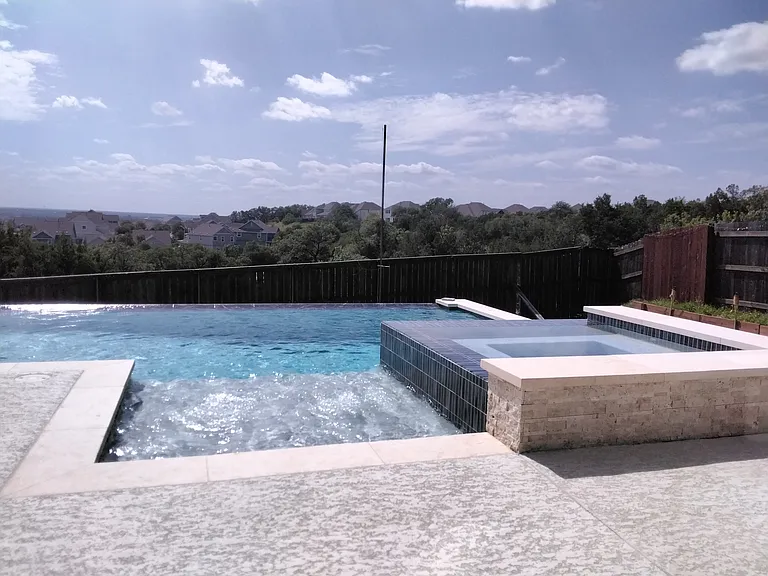 Infinity-edge pool + spa. Pool maintenance included in rent.