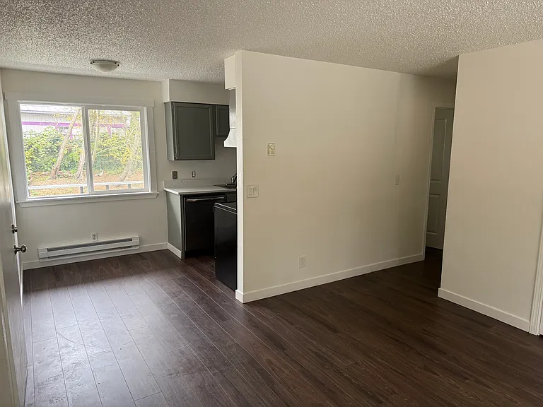 Unit 7: Kitchen and dining nook from living room. Entrance is to the left.