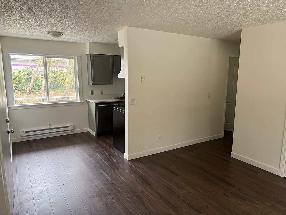 Unit 7: Kitchen and dining nook from living room. Entrance is to the left.