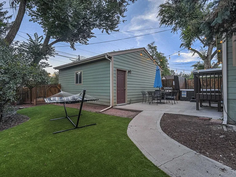 Private backyard with a hammock, hot tub, grill, table and chairs!