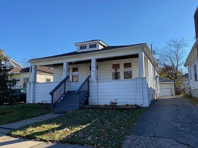 1920's Bungalow with full front porch, drive for offstreet parking and 2 car garage