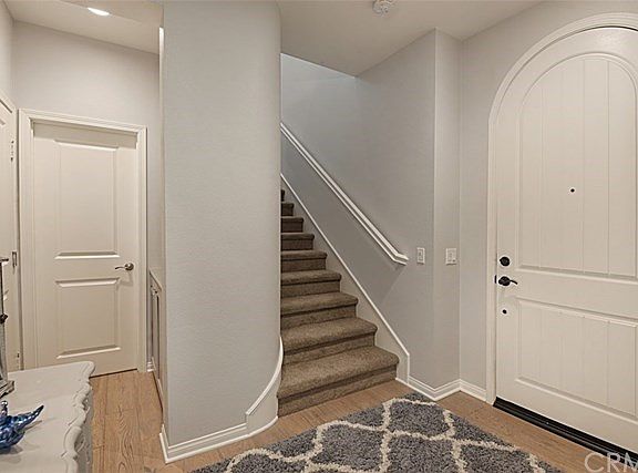 L to R garage entry, powder, stairs, front entry door.