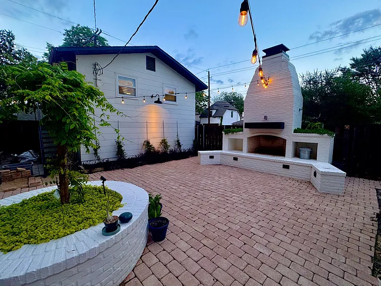 View from the gorgeous backyard courtyard looking over at the above the garage studio unit.
