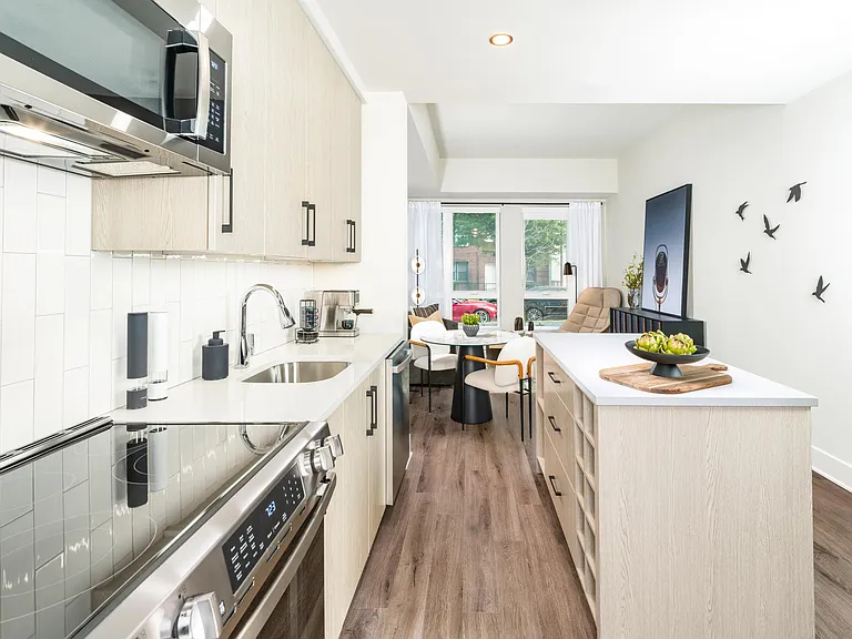 Bright, modern, and functional_this streamlined kitchen features quartz counters, designer cabinetry, and an open flow into your living space.