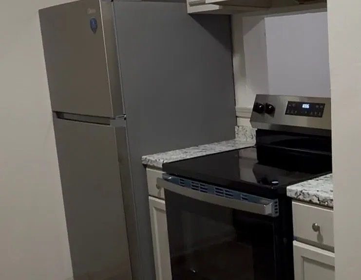 Brand new stainless steel refrigerator and electric stove, giving he kitchen a clean, modern look =. Both appliances are energy efficient, reliable, and provide plenty of space for everyday cooking and food storage.
