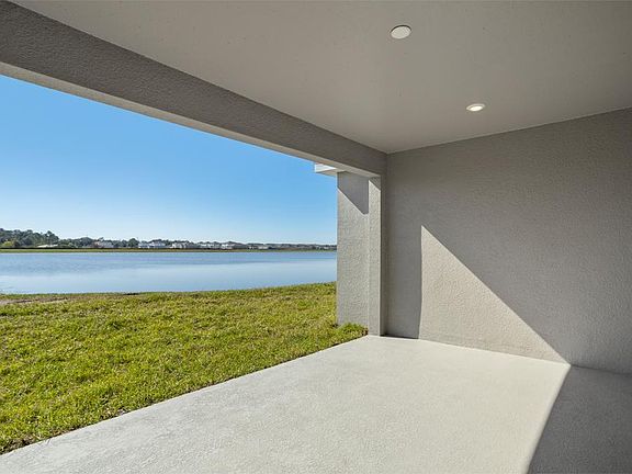 A triple sliding glass door opens to outdoor living space on your covered lanai - Everly by Highland