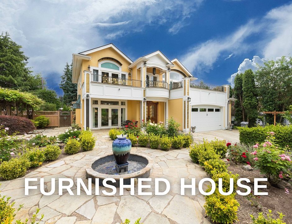 Welcome to our charming yellow villa_ with white trim, arched windows, and circular stone fountain in a landscaped courtyard.
