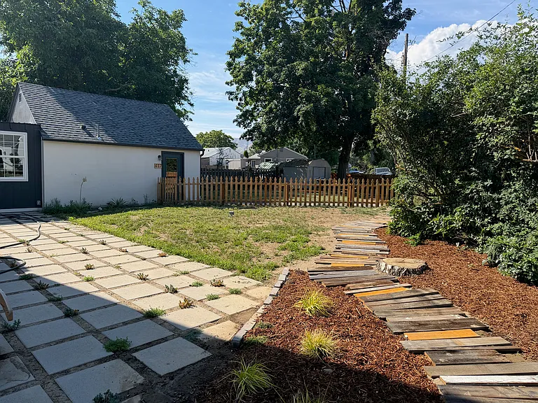Backyard includes eco-lawn, large patio and boardwalk path