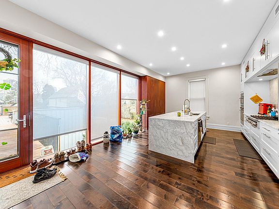 Gorgeous Modern Kitchen - Abundant natural light, Quartz countertops, sleek White cabinetry, stainless steel appliances, and large island w/ bonus seating!