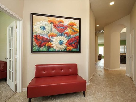 A large entry with room for a seat! Tile flooring and high ceilings.
