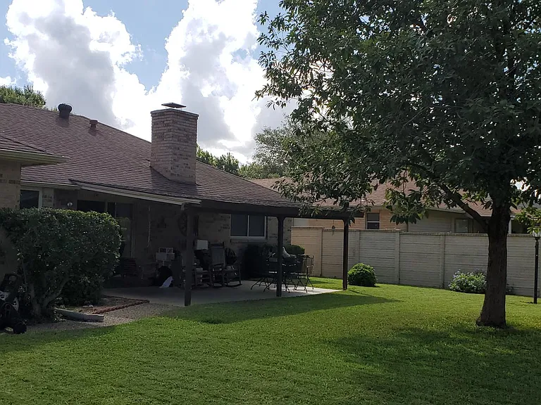 Charming landscaped backyard with great shade.