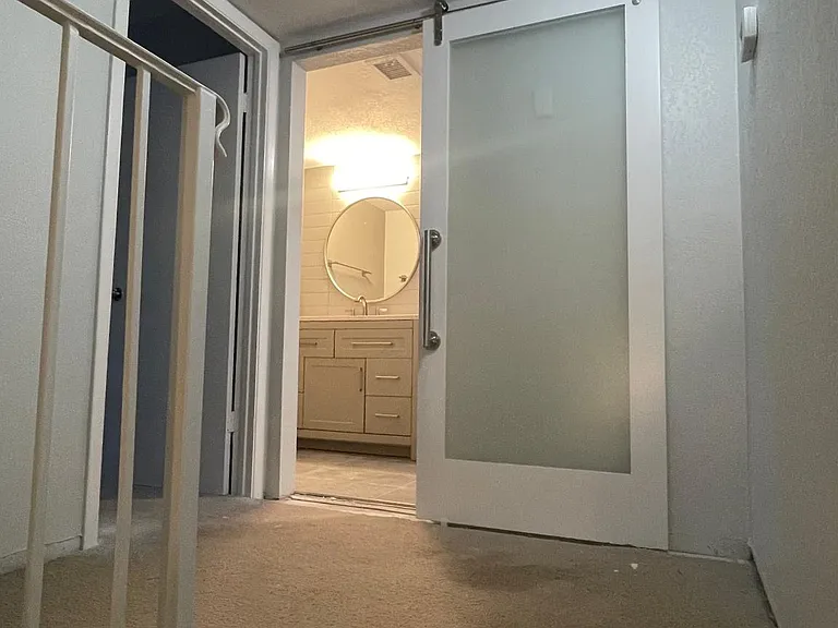 Upstairs landscaping showed new barn door leading to remodeled bathroom.