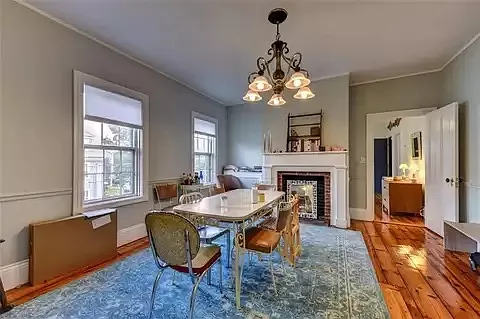 Large dining room (or living room) with decorative fireplace.