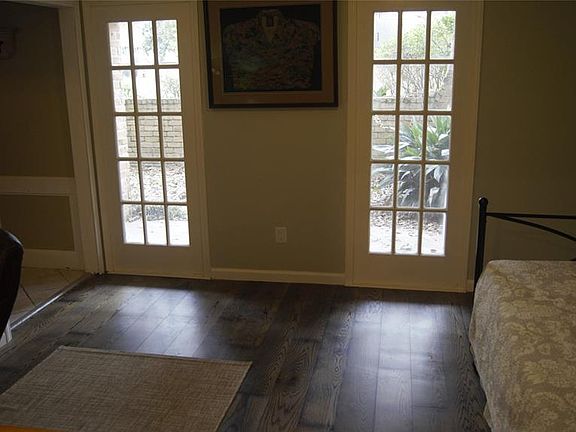 Formal dining room with beautiful floors with a view to the side garden and porch area.