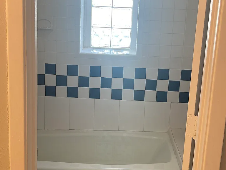 Vintage tile and glass-block windows in the bathroom.