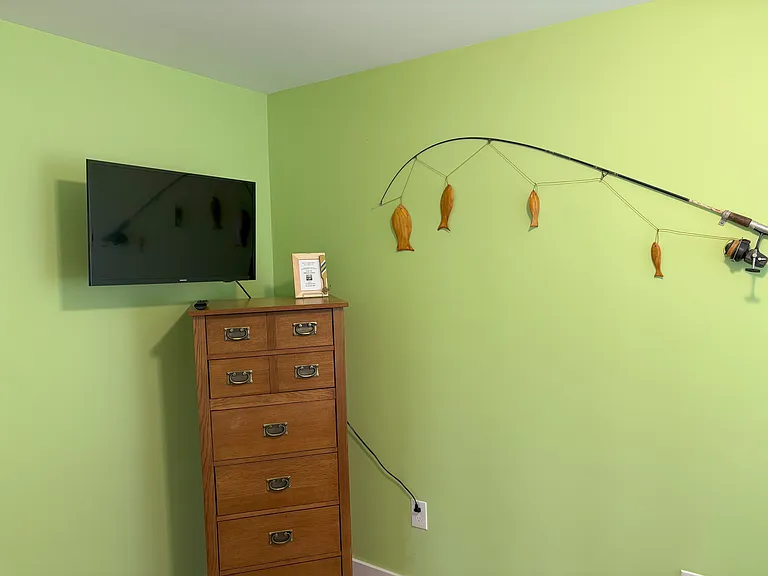 Bunk bedroom with TV, dresser and closet
