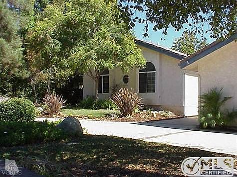 Partial view of front with front circular drive visible in addition to the entry to the breezeway.