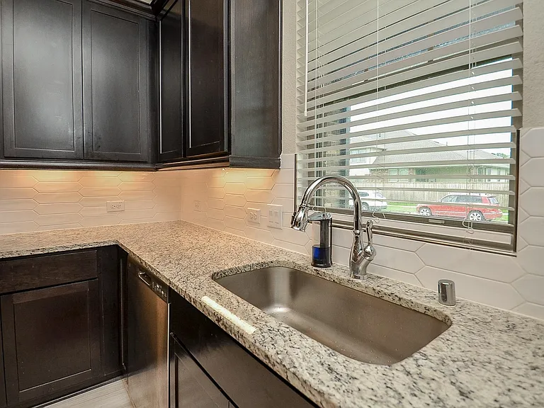 Modern kitchen with discreet under-cabinet fluorescent lighting.