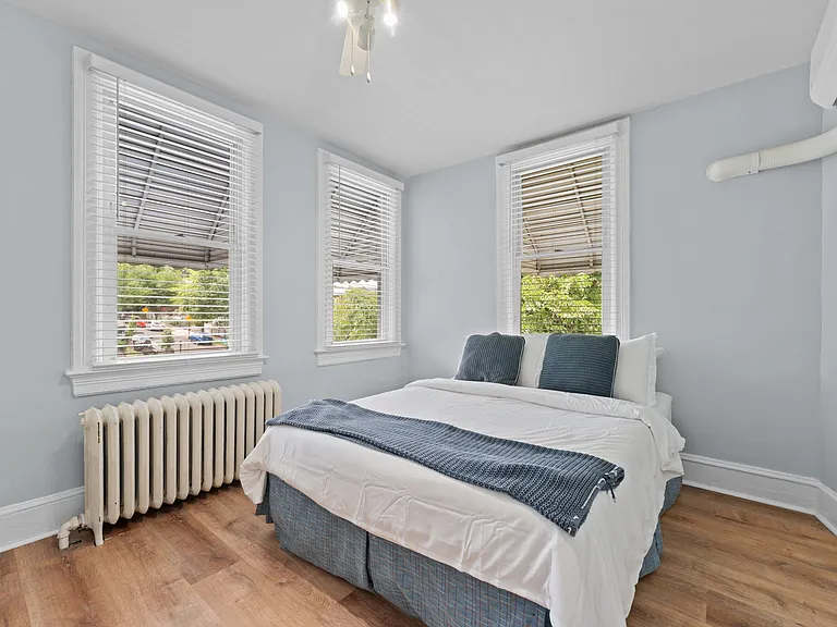 Lighted ceiling fans & lots of windows grace the master bedroom