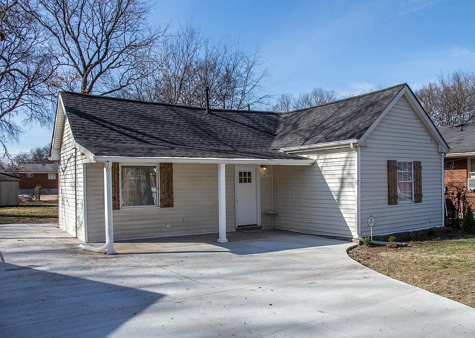 Main front of home with pavement for parking
