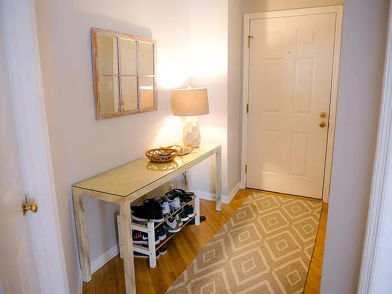 furnished entry shows space large enough for console table or bench and shoe storage