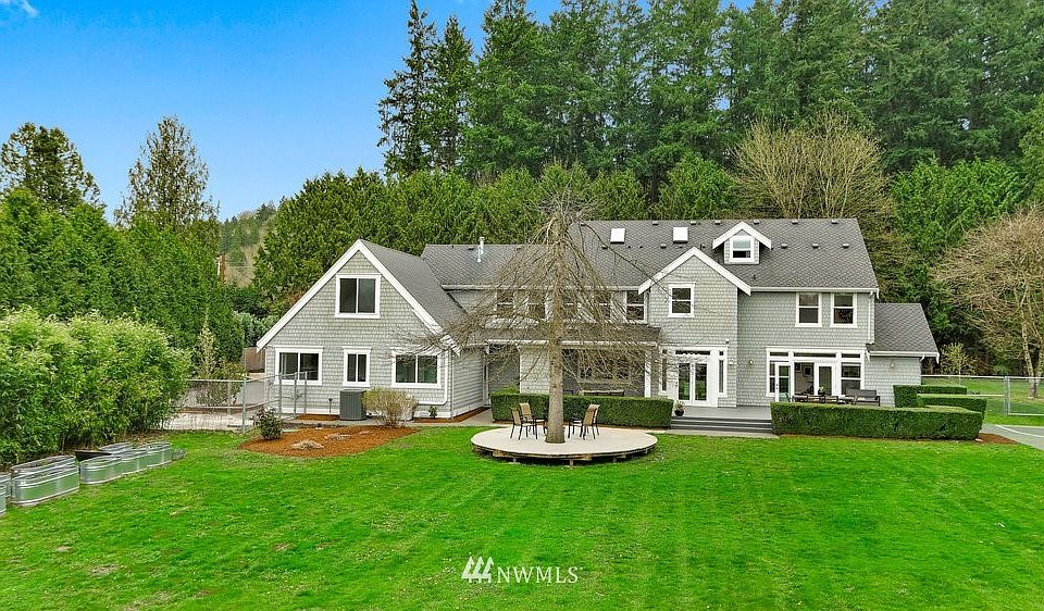 Off the Historic Red Brick Road (circa 1913) behind a gate, a circular drive leads toward this showstopper home! 5 bedrooms (including main floor guest suite).