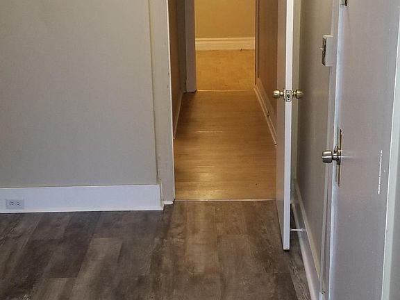 Hallway leads to bedroom on left, and 2nd room at end of hallway.