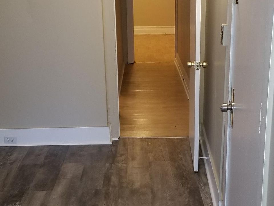 Hallway leads to bedroom on left, and 2nd room at end of hallway.