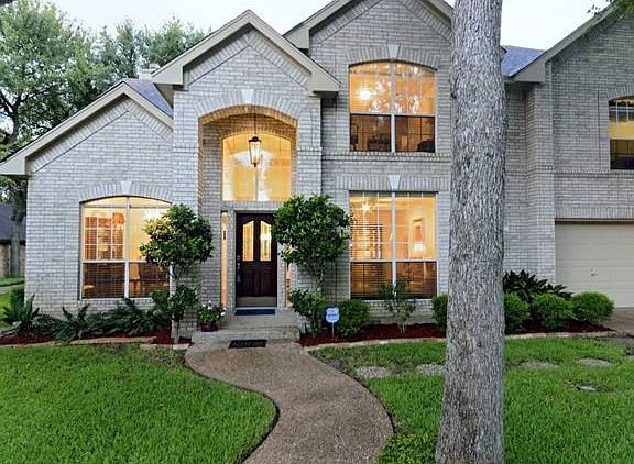 This is a closer photo of the front and taken during the twilight time of the evening.  The curved walkway is waiting for your entry into this lovely home so you can see first hand what it has to offer.