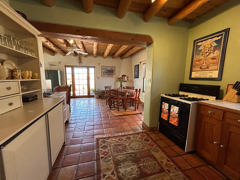 View from the Nambe Casita kitchen looking towards the dining area on the left, the living room area on the right and the entry door and windows.