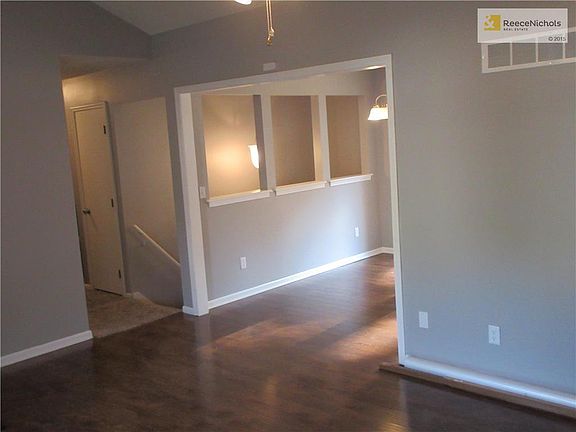 Looking toward the hallway, dining area, and stairs you can appreciate the decorative ledge and wall cutouts.