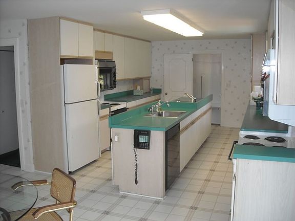 reverse angle of kitchen and center island w/ 2 large sinks and 2 dishwashers