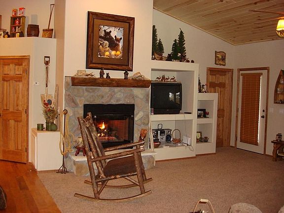 Great room features stone face gas fireplace