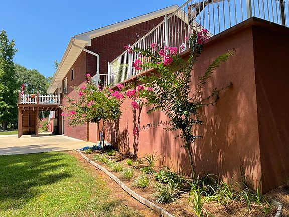 Looking north along the back of the house. There are two upper level patios, one outside the backdoor, and one on the south side.