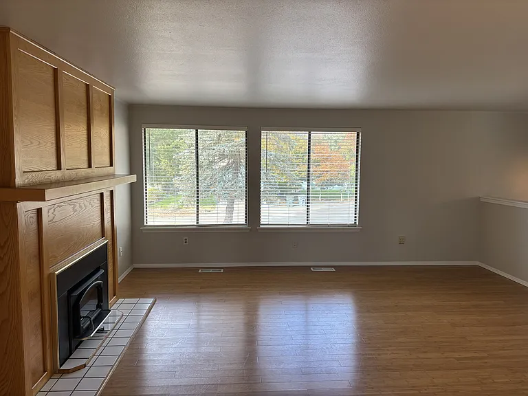 Living room view from dining room and the large windows allowing plenty of light