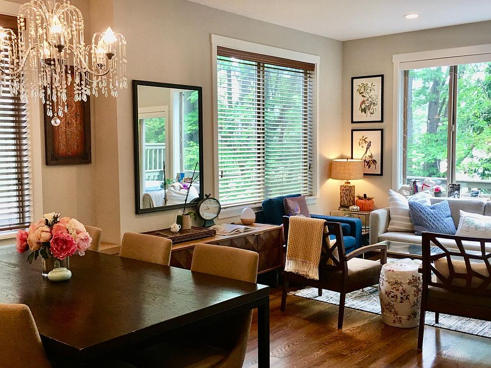 Living room and dining area. Hardwood floor, large windows, furnished.