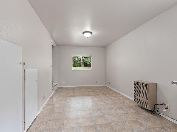 Open living room has storage and natural gas heat.