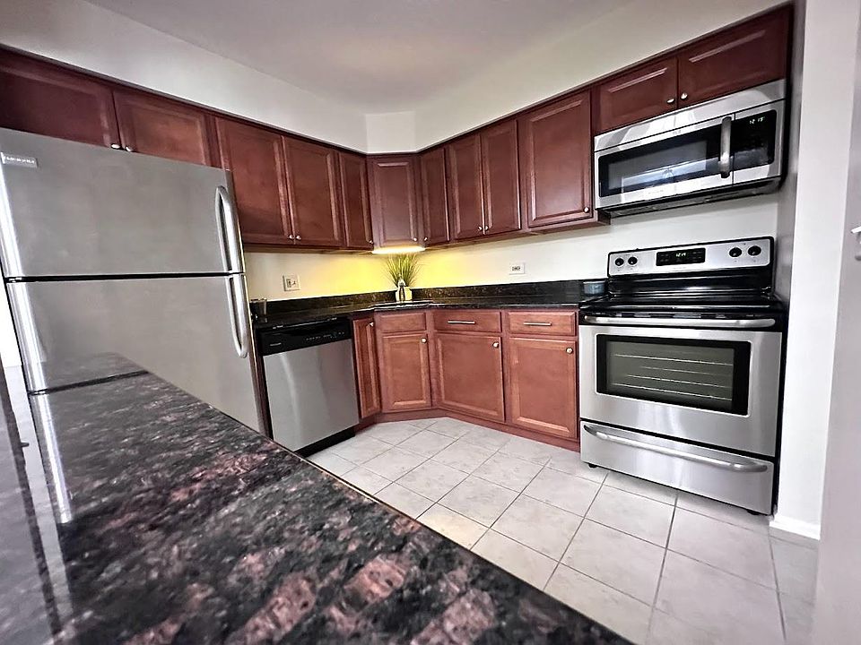 Kitchen has granite countertops and bar top.