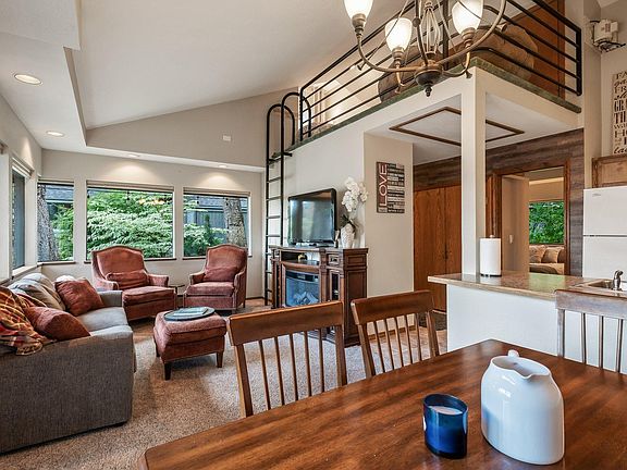 Upper loft area above living room has a queen bed and desk/lounging area.