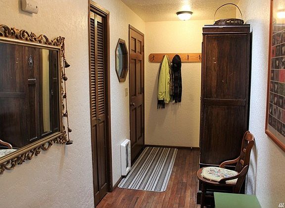 Entryway with picture window. Solid wood door.