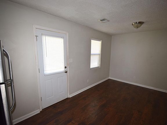 Eat-in kitchen with door leading to back deck and parking lot