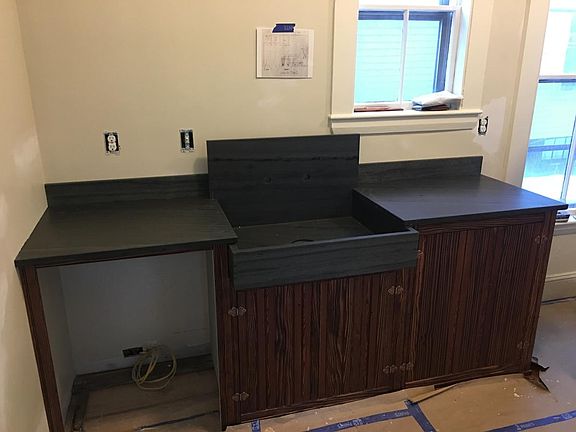 New kitchen with farm sink, dishwasher and slate countertops
