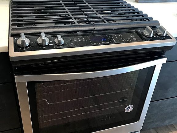 Gas, stainless steel range with convection oven.