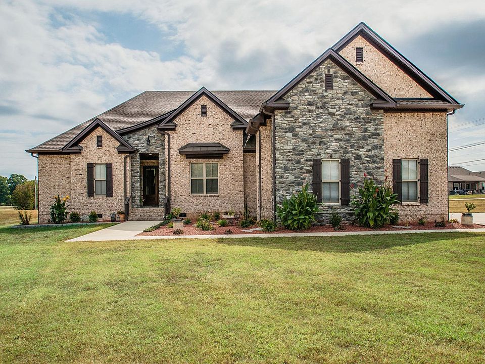 CUSTOM BUILT ALL BRICK HOME WITH STACKED STONE ACCENTS