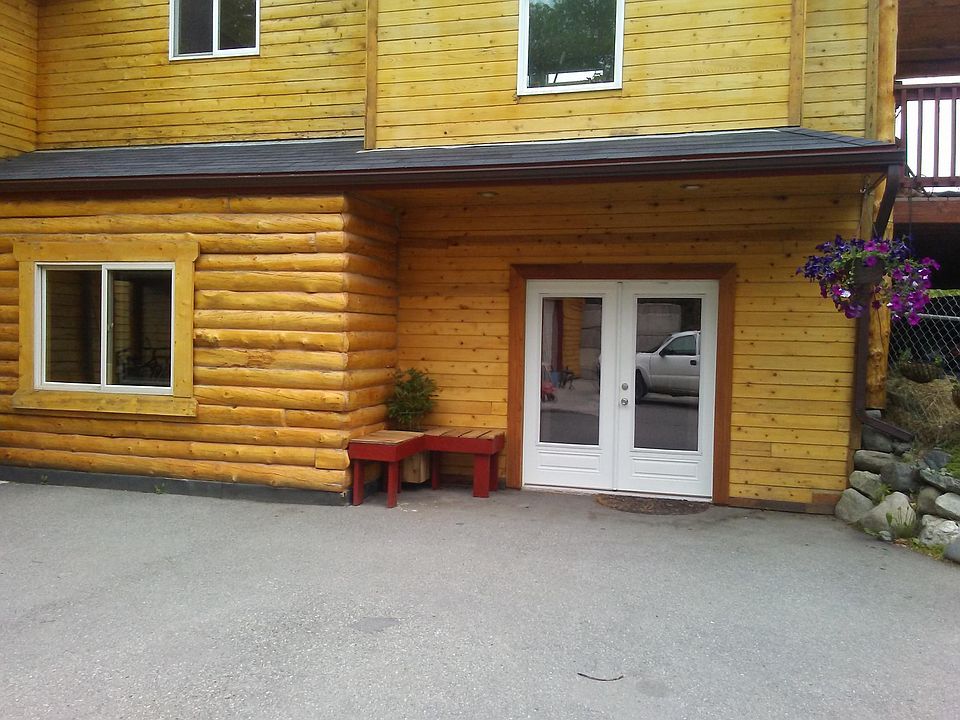 Front door to walk out basement apartment, With unheated storage spaces with the window to the left.